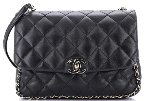 Black quilted leather handbag with gold-tone chain and clasp on white