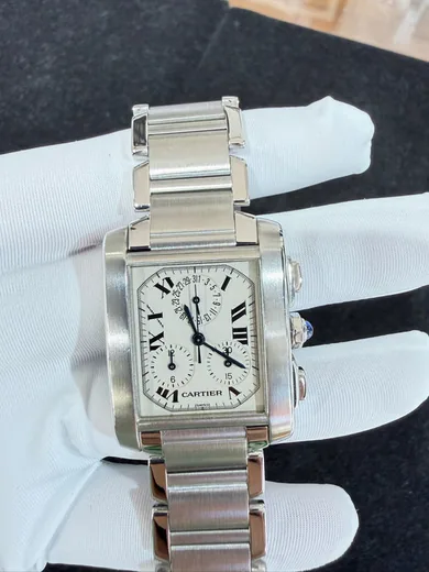 Cartier wristwatch held in a gloved hand